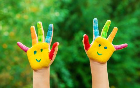 colourful Kids painted hands - yellow, green and red