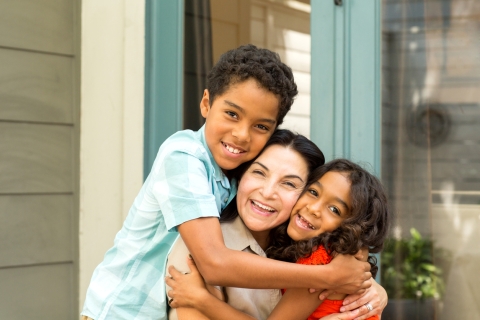 Mother being hugged by her two children