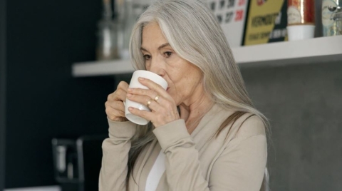 Middle aged woman drinking from a mug