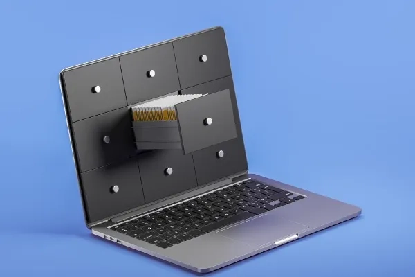 laptop-screen-and-stack-of-files-cabinet-with-paper-documents