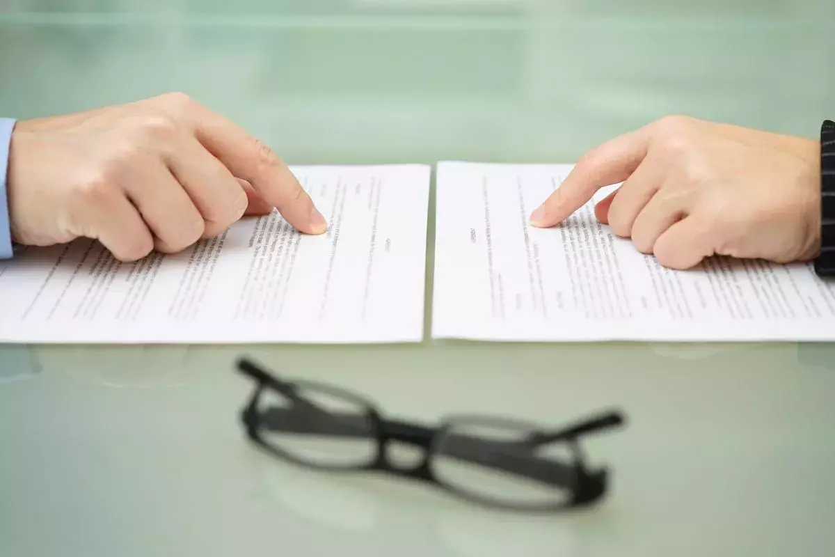 Man and wife are reading divorce agreement with the hands