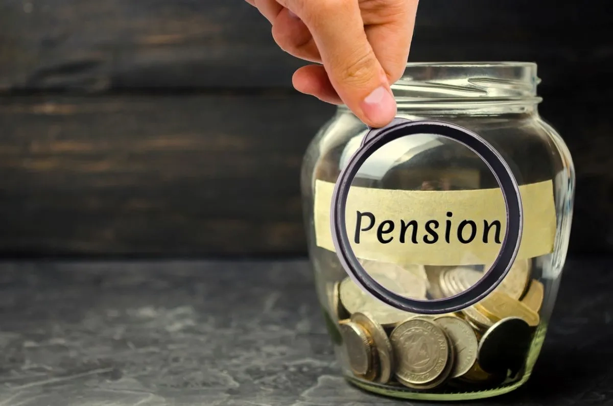 Glass jar with coins and the inscription "Pension"
