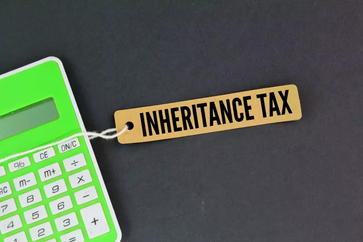 green calculator and a paper tag with the words Inheritance