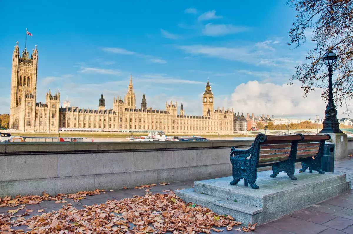 house of parliament and a bench on the other side