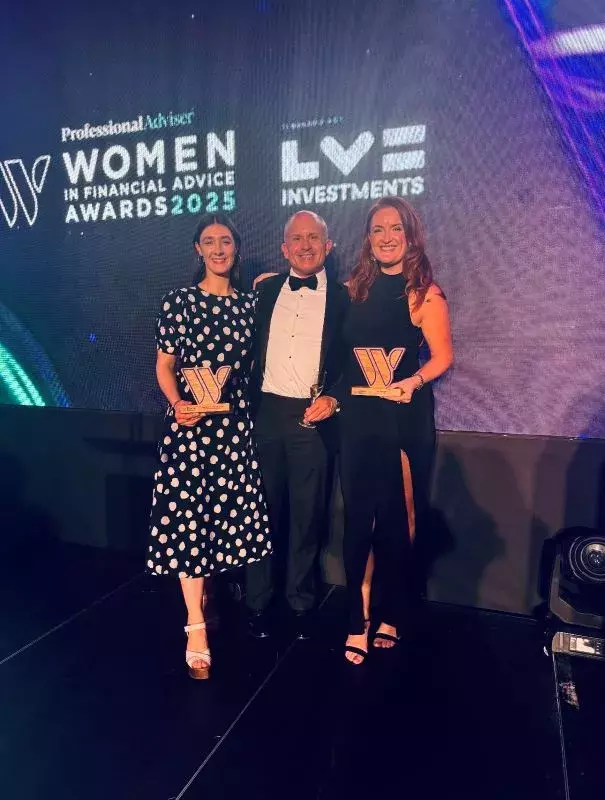 Winners and CEO on stage with trophies