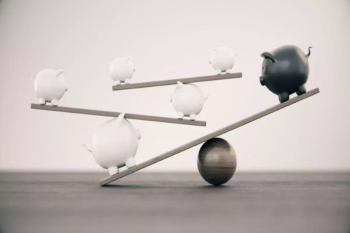 White And Black Ceramic Piggy Banks On A Seesaw