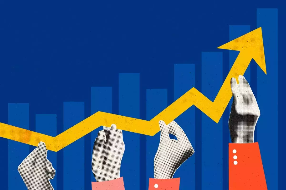 Blue bar graph with yellow arrow pointing upwards held up by hand