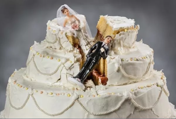 broken wedding cake with two figures man and woman