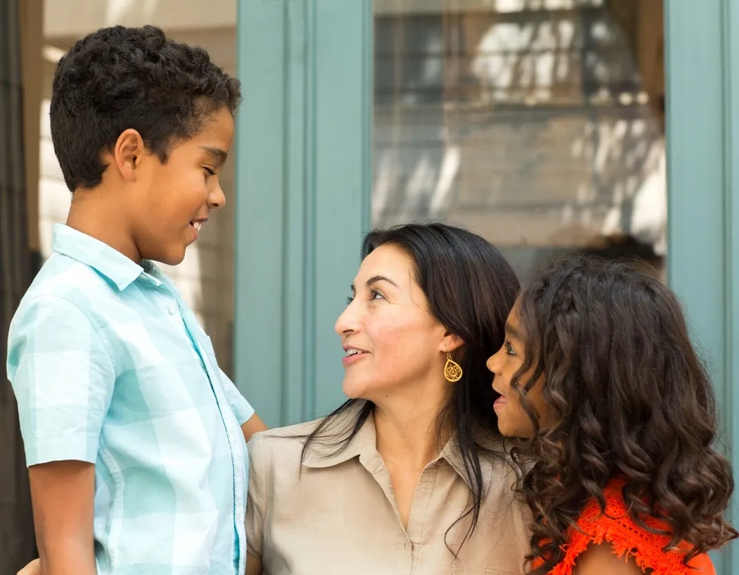 Mother with daughter talking to son