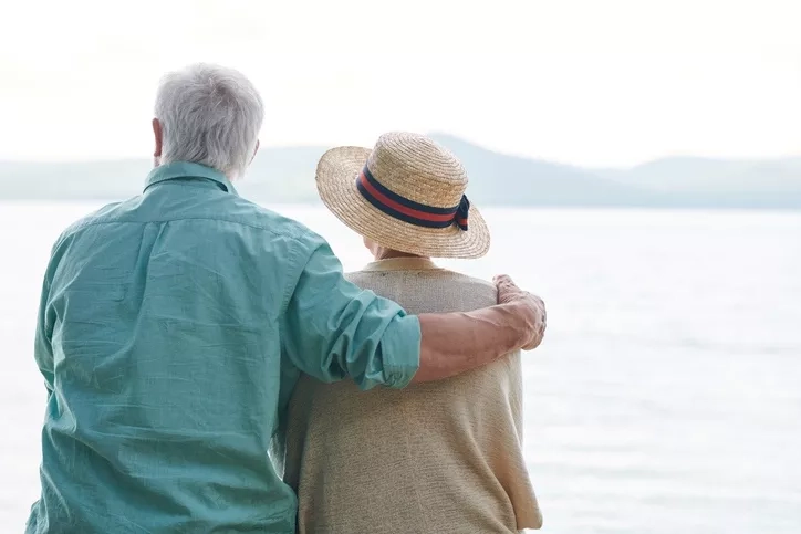 couple looking at the sea and the mountains in the horizon