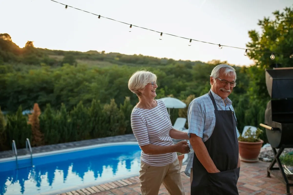 Woman helping husband tie apron