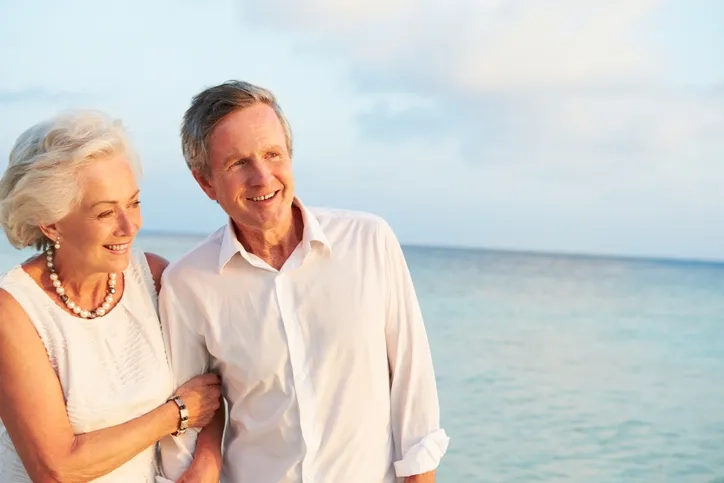 Couple with arms interlinking 