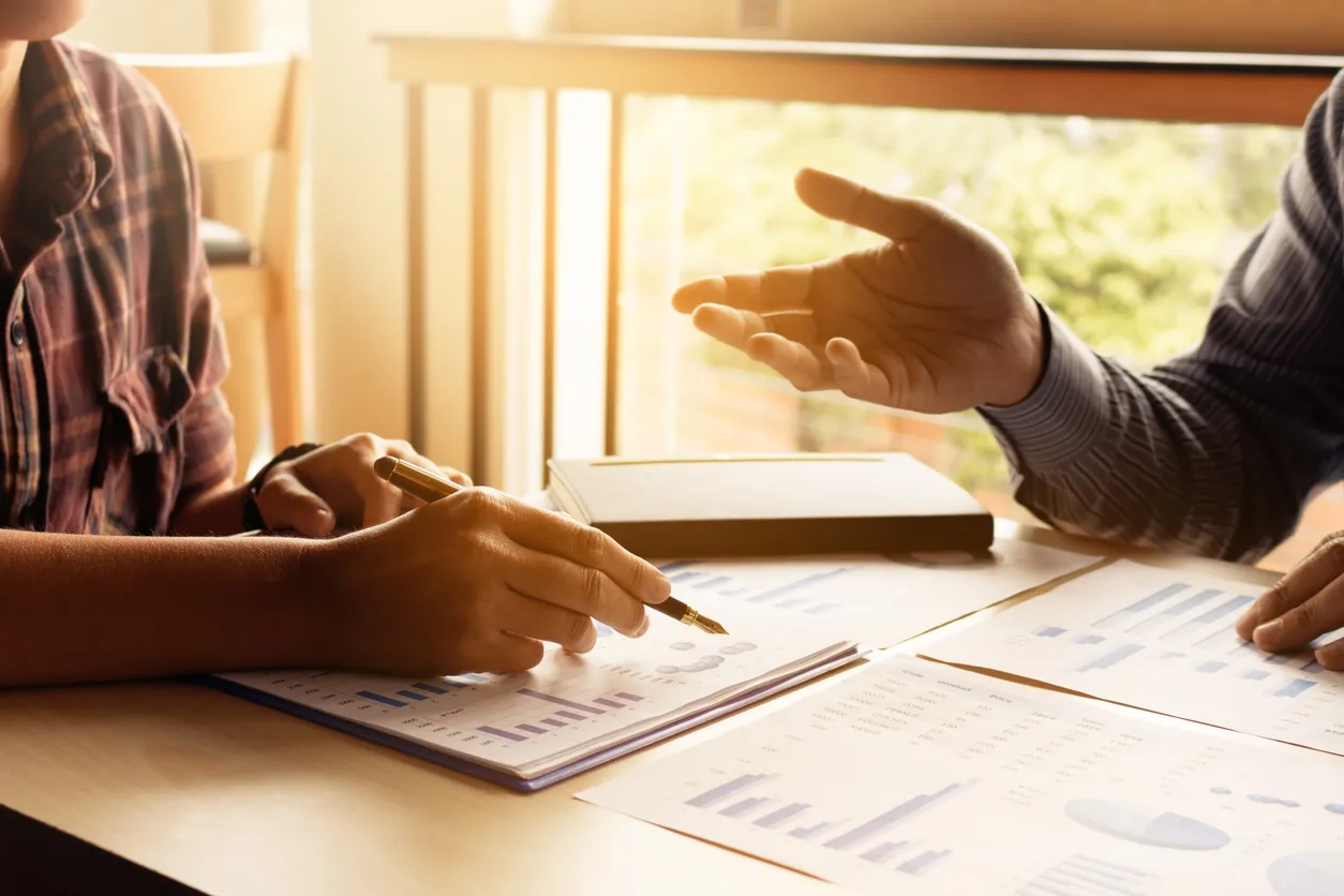 Two start up person analyse data result about budget summary report on table at home office.