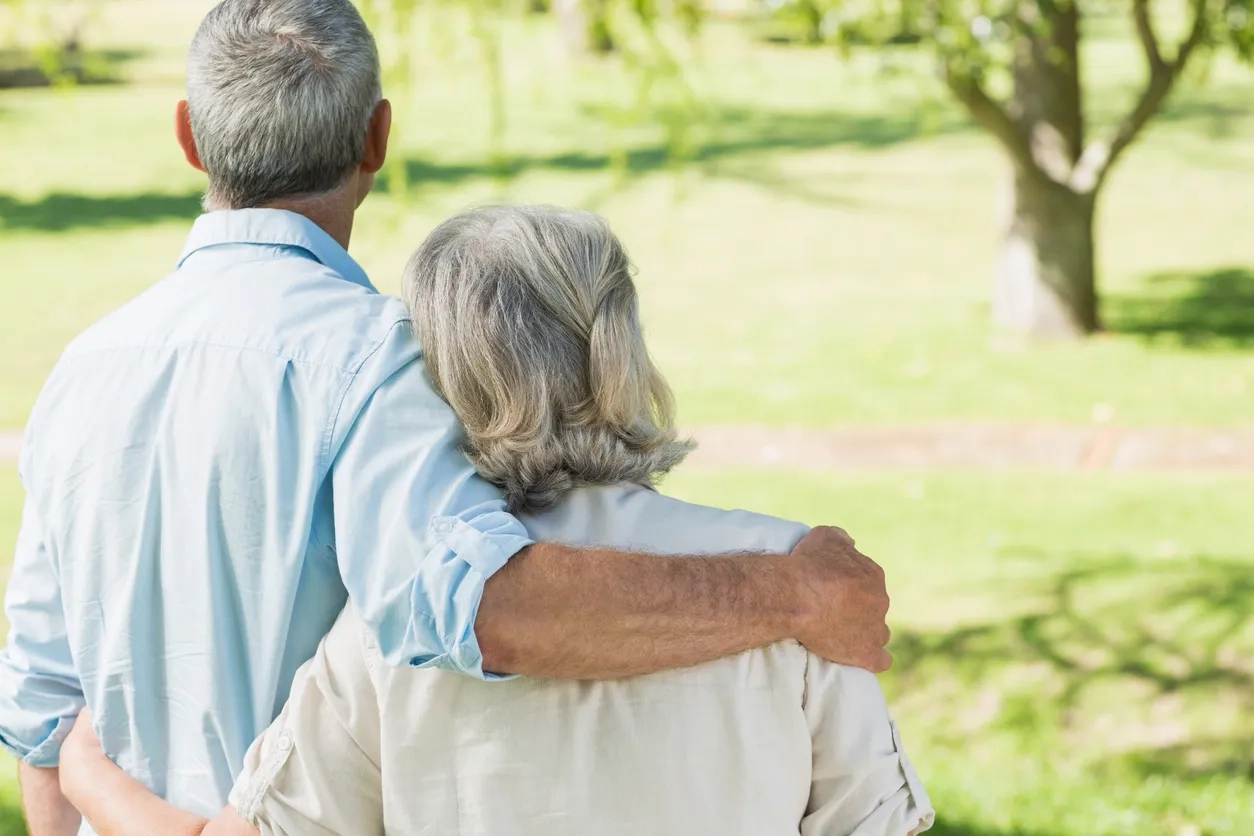 Elderly couple looking in to distant view of countryside