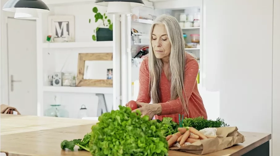 Middle aged woman cooking in kitchen