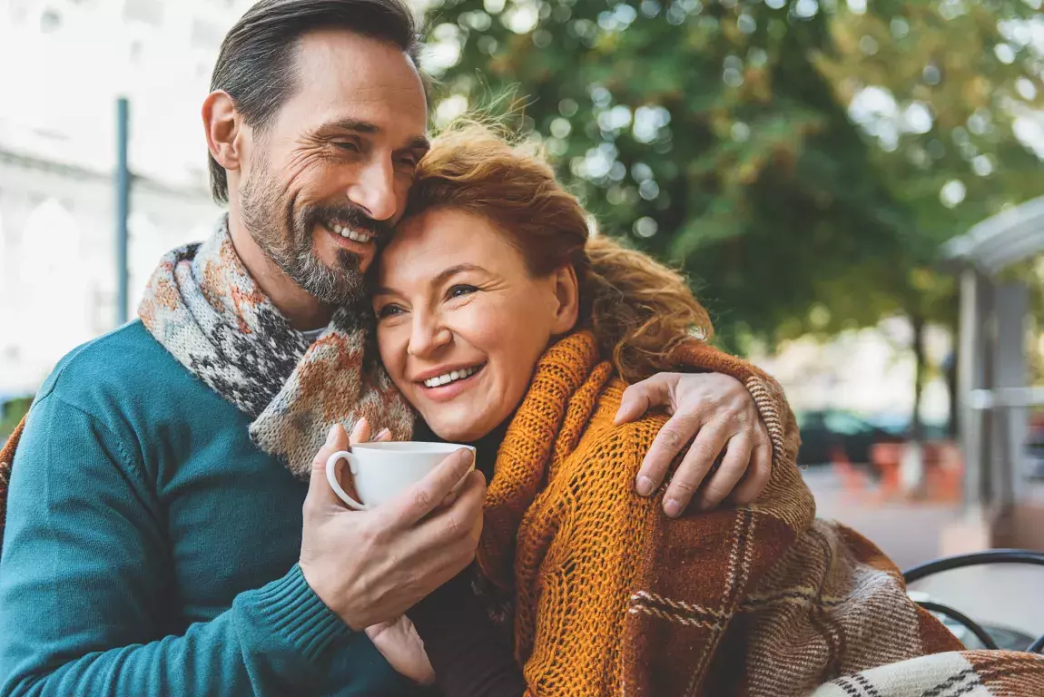Mature couple smiling and wearing warm clothes