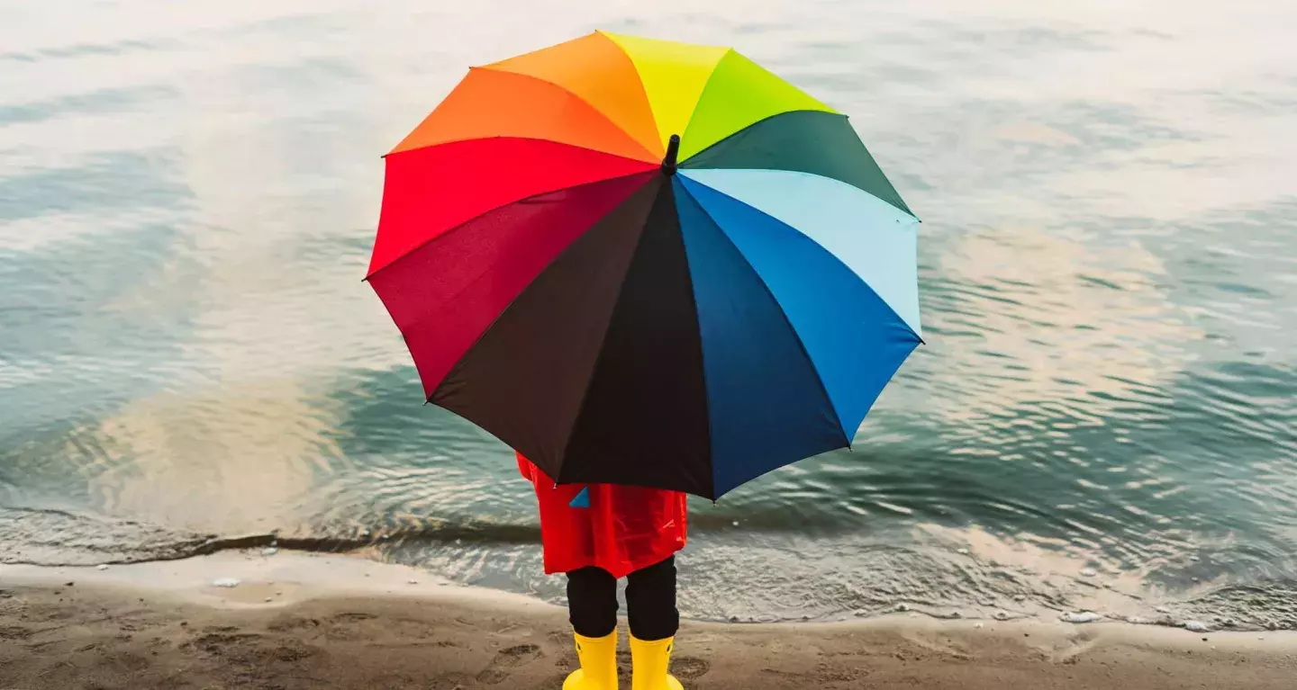 A child with a colourful umbrella