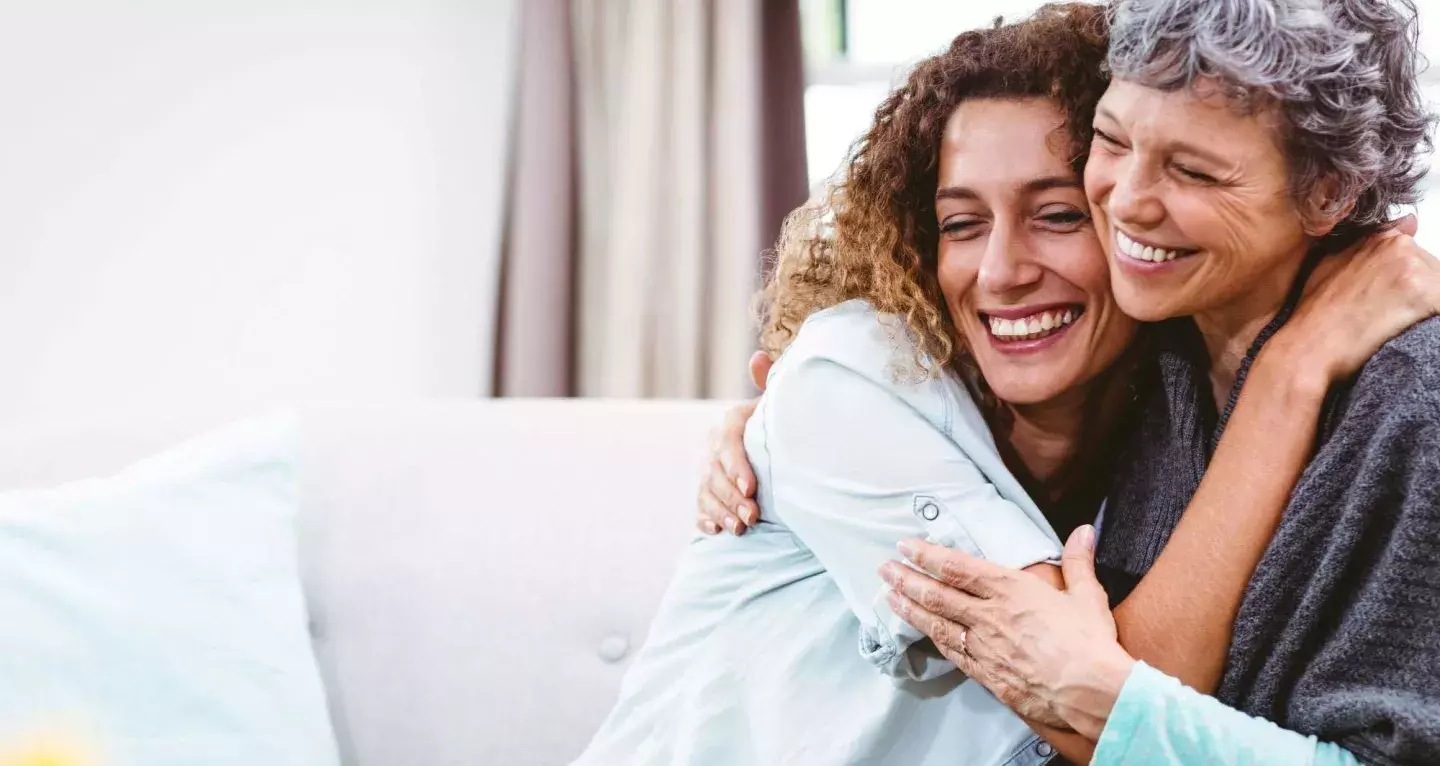 two women hugging and smiling
