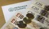 Pile of notes and coins on letter with the HMRC header