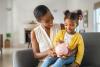 Mother sat with her daughter on her knee, both wearing yellow