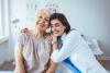 Elderly woman hugging caregiver
