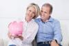 Couple holding big pink Piggybank