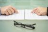 Man and wife are reading divorce agreement with the hands