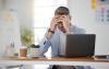 Laptop, headache and stress with a business man in the office for deadline management as a professional boss.