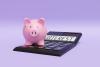 Pink piggy bank standing on a calculator showing INTEREST on purple background