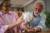 Senior couple count money from the piggy bank and save money together