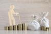 Senior man and money bag on wooden background