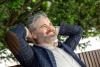 Confident senior businessman relaxing outdoors in a stylish suit and smiling 