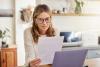 woman with laptop and paperwork for pension savings