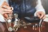 woman hand coins with calculator on desk