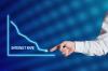 Businessman hand points to the word interest rate with a decreasing chart