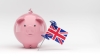 Piggybank and the English flag. On white color background. Isolated with clipping path