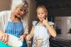 A grandmother and granddaughter baking together