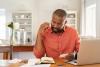 A man looking worried at his paperwork.